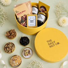 Load image into Gallery viewer, The Nourish & Memories Box premium Diwali gift hamper with protein mix, gourmet cookies, Satvik bites, personalized photo magnet, and festive gift packaging